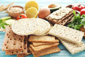 Poster - Crispbread with cream cheese and vegetables on blue wooden table