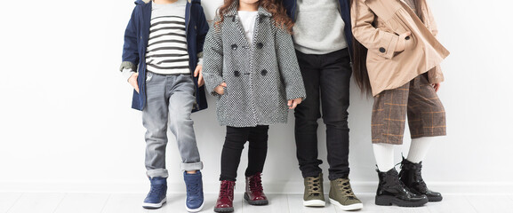 Group of preschool kids wearing autumn clothes. Children Friendship Togetherness. Child clothing, foot wear and fashion.