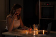 © Анжелла Антоновская - A girl sits in the kitchen in the evening drinking wine and talks via video link with her man