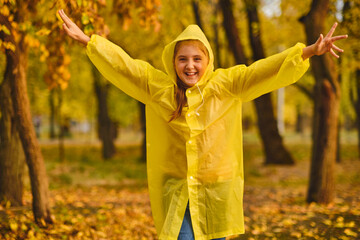 Wall Mural - kid playing on the nature outdoors in autumn rain