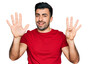 © Krakenimages.com - Hispanic man with beard wearing casual red t shirt showing and pointing up with fingers number nine while smiling confident and happy.