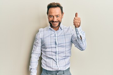 Poster - Middle age man wearing business clothes smiling happy and positive, thumb up doing excellent and approval sign