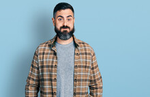 Hispanic Man With Beard Wearing Casual Shirt Puffing Cheeks With Funny Face. Mouth Inflated With Air, Crazy Expression.