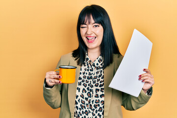 Poster - Young hispanic woman wearing business style drinking cup of coffee winking looking at the camera with sexy expression, cheerful and happy face.