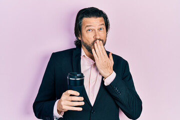 Poster - Middle age caucasian man wearing business clothes drinking a cup of coffee covering mouth with hand, shocked and afraid for mistake. surprised expression