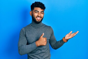 Sticker - Arab man with beard wearing turtleneck sweater showing palm hand and doing ok gesture with thumbs up, smiling happy and cheerful