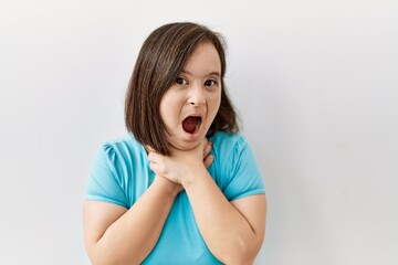 Wall Mural - Young down syndrome woman standing over isolated background shouting and suffocate because painful strangle. health problem. asphyxiate and suicide concept.