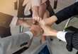 © kaweewat - Power of the new generation, Team work, Join forces to achieve the goal. Business people, managers, employees shaking hands, energizing in a circle. The organization grow with the power of the team.