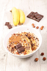 Wall Mural - bowl of oatmeal with banana and chocolate