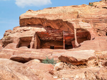 Ancient Housing Carved In Red Sand Rock In The City Of Petra, Jordan.