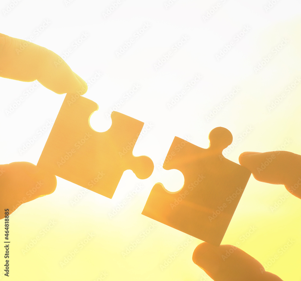 two hands of businessman to connect couple puzzle piece with sky ...