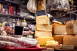 Italian food market with cheese and pepperoni, formaggio crociato fresco, Tuscan delicatessen stall display, Florence, Italy