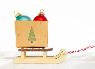 Wall Mural - box with christmas ornament stands on a sled in the snow