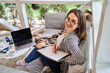 © Тарас Нагирняк - Portrait of happy smiling freelancer woman at home with notebook