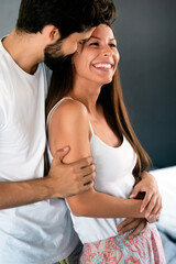 Wall Mural - Romantic happy young couple relaxing, hugging at modern home