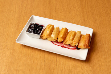 Wall Mural - Crispy cheese fried in olive oil with blueberry jam on white plate