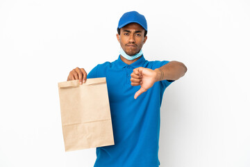 Wall Mural - African American man taking a bag of takeaway food isolated on white background showing thumb down with negative expression