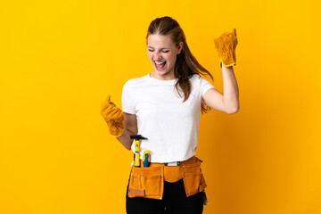 Sticker - Young electrician woman isolated on yellow background celebrating a victory