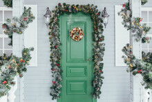Green Door Entrance To The House. Christmas Festive Deco Decorated With Christmas Tree Branches