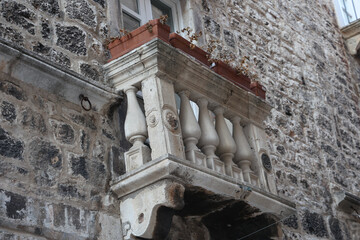 Canvas Print - Closeup of a balcony of an old stone building in Croatia