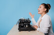 © Alexander - happy young woman is an author at a typewriter, is inspired,