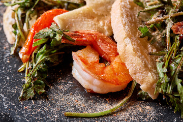 Wall Mural - Delicious dish with grilled shrimps, squid, croutons and arugula salad and spicy fried prawns. Restaurant menu, natural and organic food concept.