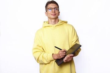 A male designer in yellow hoody holding graphic tablet