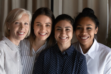 Poster - Smiling faces of friendly colleagues. Team portrait of four females coworkers of different age ethnic group. Happy diverse multiethnic women human resource of international company bond look at camera