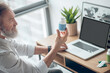 © zinkevych - A mature man holding two jars with pills
