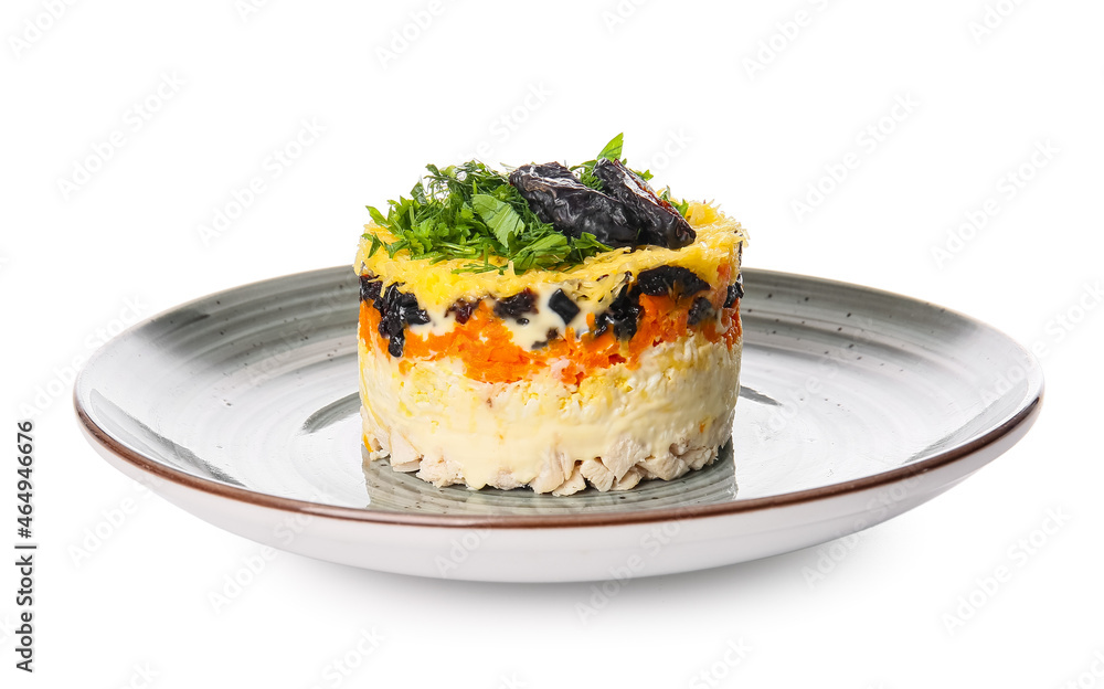 Plate with tasty layered salad with prunes on white background
