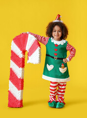 Sticker - Cute little elf with candy cane pinata on yellow background