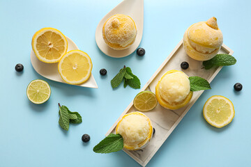 Wall Mural - Plate with tasty ice creams in lemon peels on color background