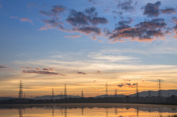 Wall Mural - lined high voltage poles and reflections in the beautiful morning water and lake view, mae moh, lamp