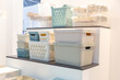Plastic containers on a shelf for organizing home space, order and interior, sale of household goods
