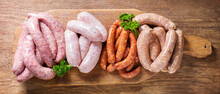 Various Kind Of Types Of Fresh Sausages On Chopping Board