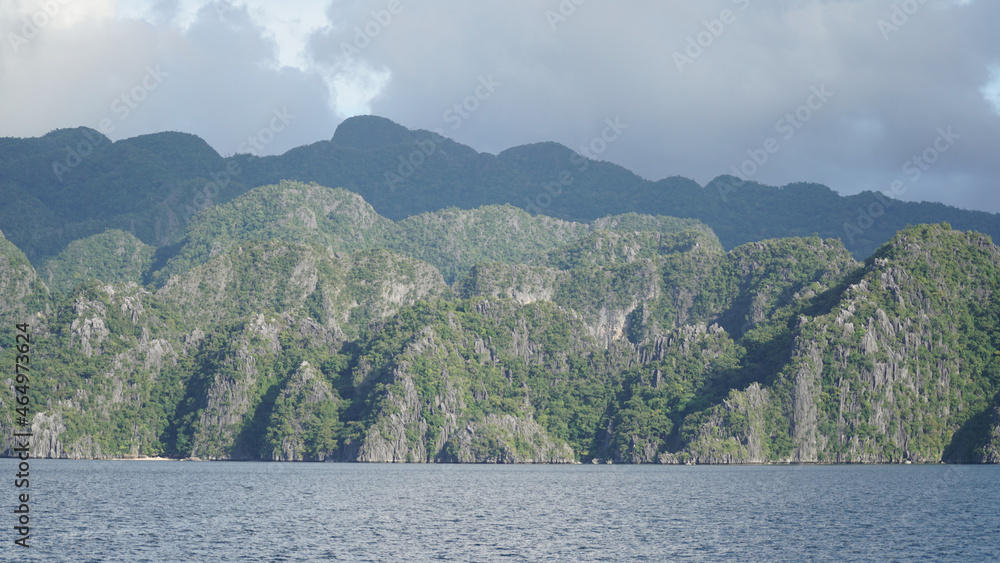 Ocean and jagged rock landscapes with turquoise water at Coron Island in Palawan, Philippines.