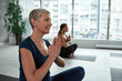 © Svitlana - Active middle-aged woman meditate practice yoga on class