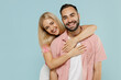 © ViDi Studio - Young smiling happy cheerful couple two friends family man woman in casual clothes looking camera hug together isolated on pastel plain light blue background studio portrait People lifestyle concept.