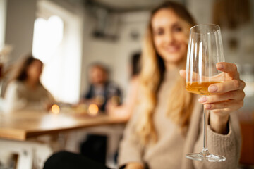 Wall Mural - Close-up image of white wine glass. Delicious gastronomy. Friends gatheringtogether at cafe