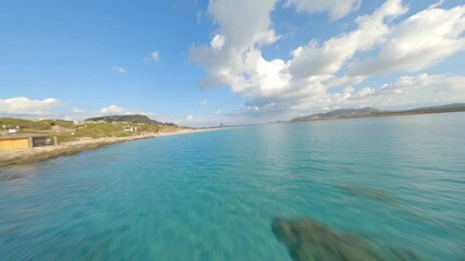 Canvas Print - FPV video, view from above, flying at high speed over a turquoise water with a beautiful  white sand beach La Pelosa Beach, Stintino,. Sardinia, Italy.