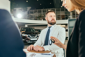 Wall Mural - Multi ethnic couple signing papers about car purchase