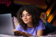 © ReeldealHD images - Young adult gen z female student using a laptop in her bedroom