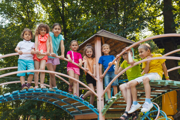 Wall Mural - The little kids stand on a bridge in the playground