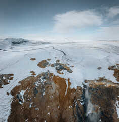 Wall Mural - Aerial Drone view of Hverir in Winter with Snow. Icelandic Hverarond is geothermal area in Myvatn, Iceland. Hverir is a famous tourist destination located near Lake Myvatn, Krafla northeastern region