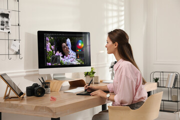 Poster - Professional retoucher working on graphic tablet at desk in office