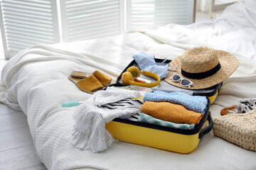 Canvas Print - Open suitcase full of clothes, shoes and summer accessories on bed