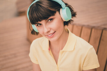 Poster - Photo of nice young brunette lady wear yellow polo headphones outside in city