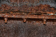 Rusty metal girder under a bridge