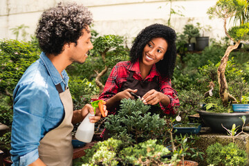 Wall Mural - happy botanist talking to colleague at plant nursery