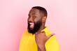 Photo of afro american cheerful positive young man point finger empty space sale news isolated on pink color background